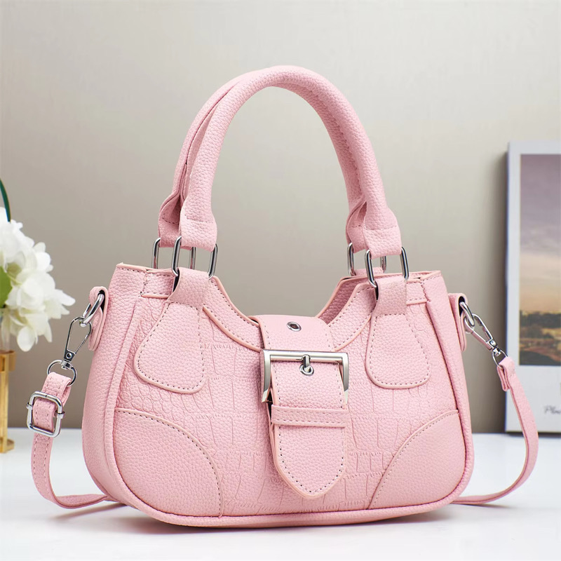 Sac à main rose Sac à main rose avec poignées et bandoulière, au design élégant et moderne.